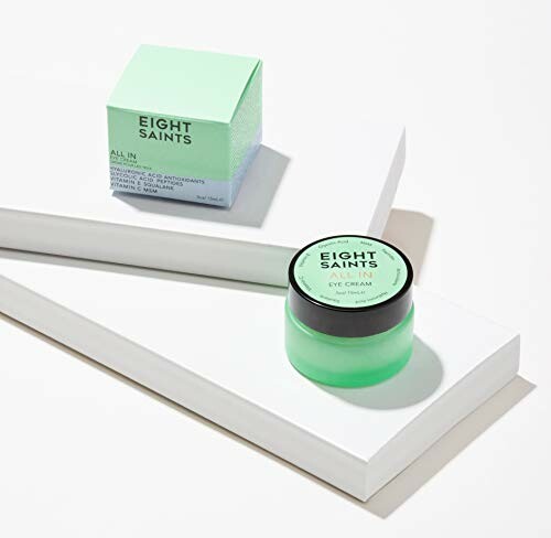 Eight Saints eye cream and packaging on white platform.
