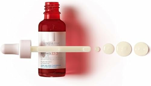Red bottle of Retinol B3 Serum with dropper and liquid drops
