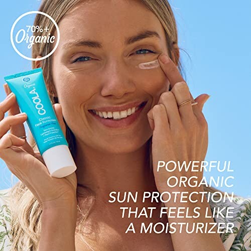 Woman applying organic sunscreen on her face.