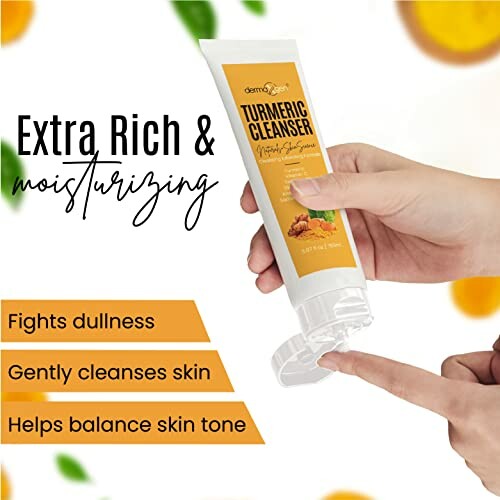 Hand holding turmeric cleanser tube with benefits listed.