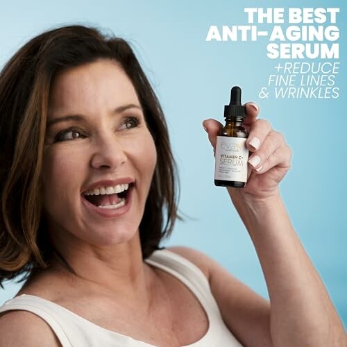 Smiling woman holding a bottle of anti-aging vitamin C serum with text about reducing fine lines and wrinkles.